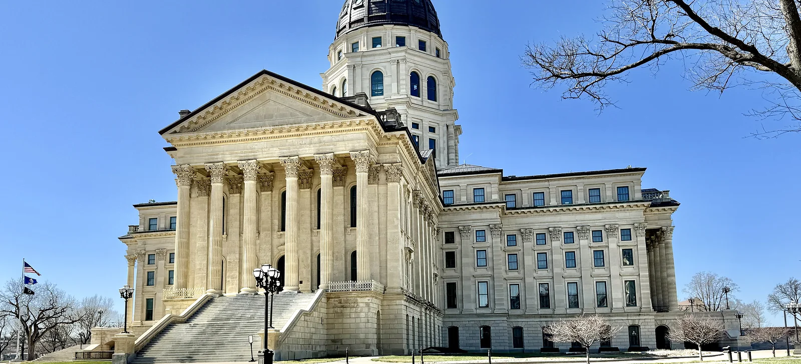 The Kansas State Capitol building in Topeka under a clear sky